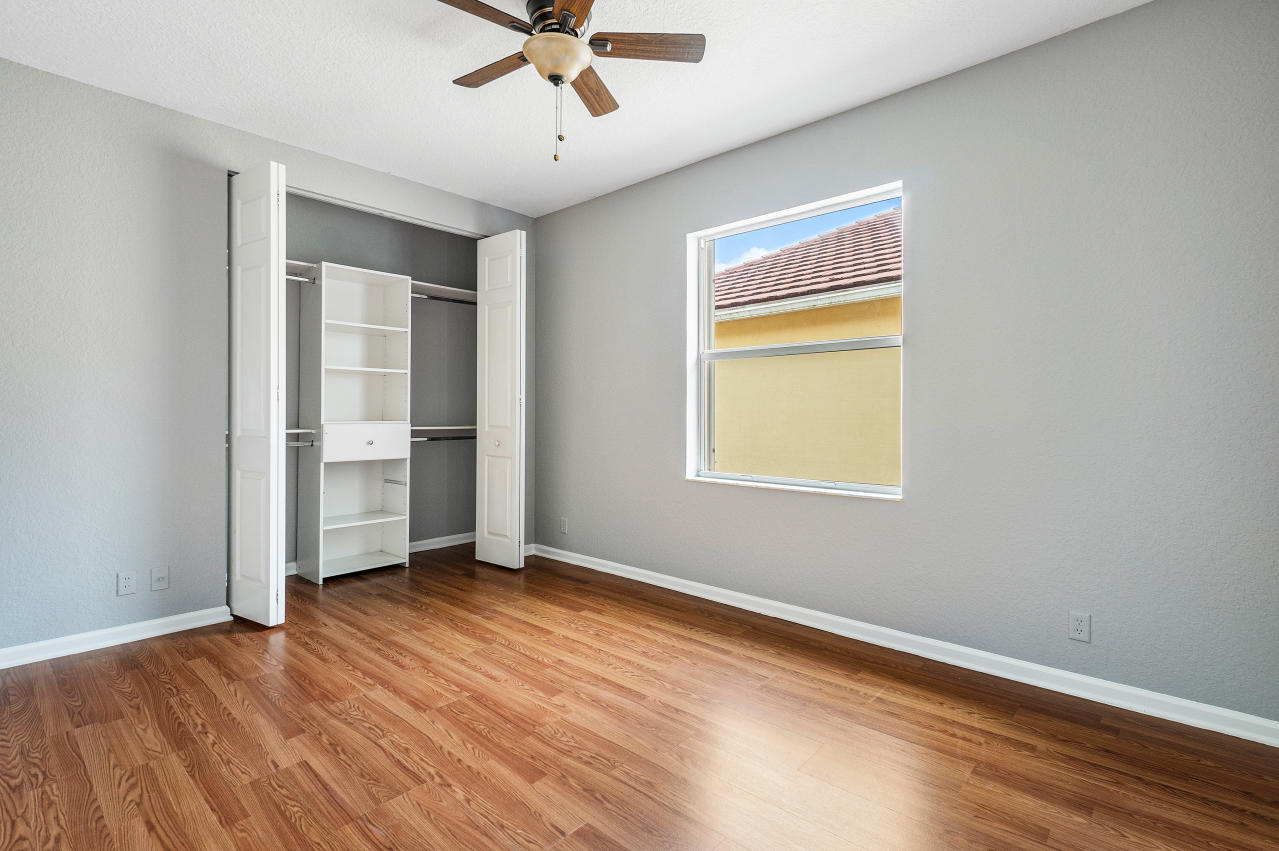 415 Mulberry Grove Road Royal Palm Beach, FL 33411 - Photo 24 of 39 a view of an empty room with a window and wooden floor