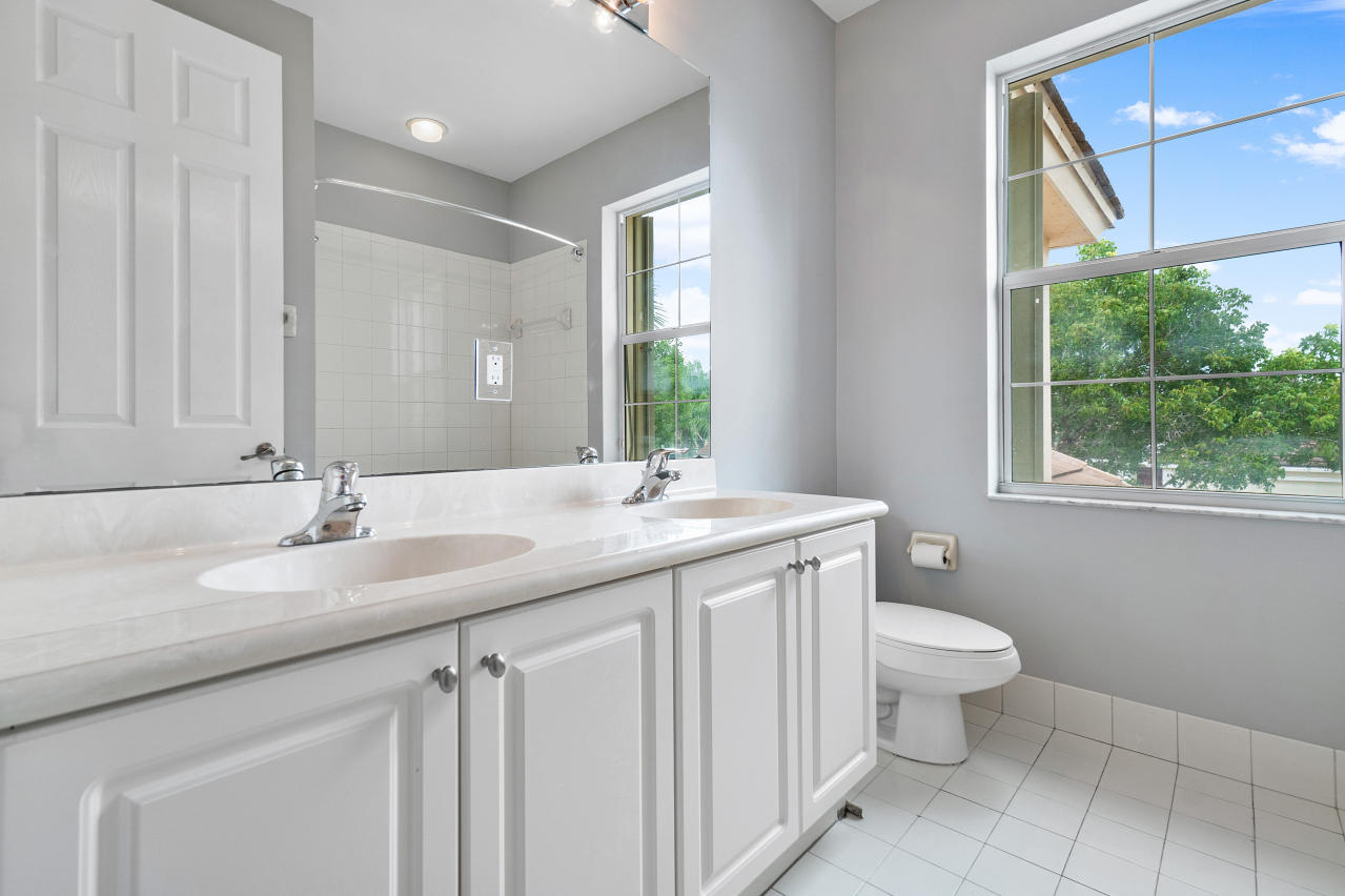 415 Mulberry Grove Road Royal Palm Beach, FL 33411 - Photo 25 of 39 a bathroom with a granite countertop sink a toilet and a mirror