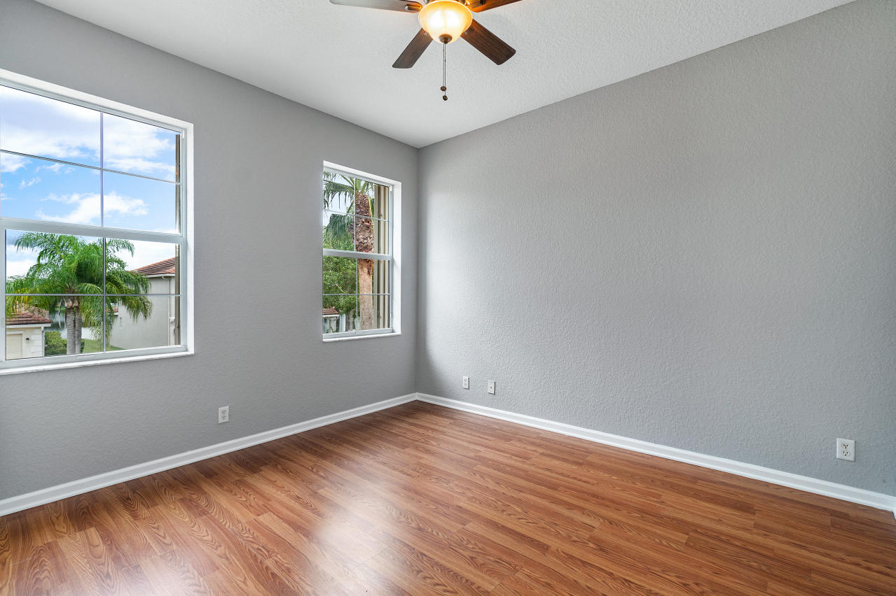415 Mulberry Grove Road Royal Palm Beach, FL 33411 - Photo 26 of 39 a view of empty room with wooden floor and fan