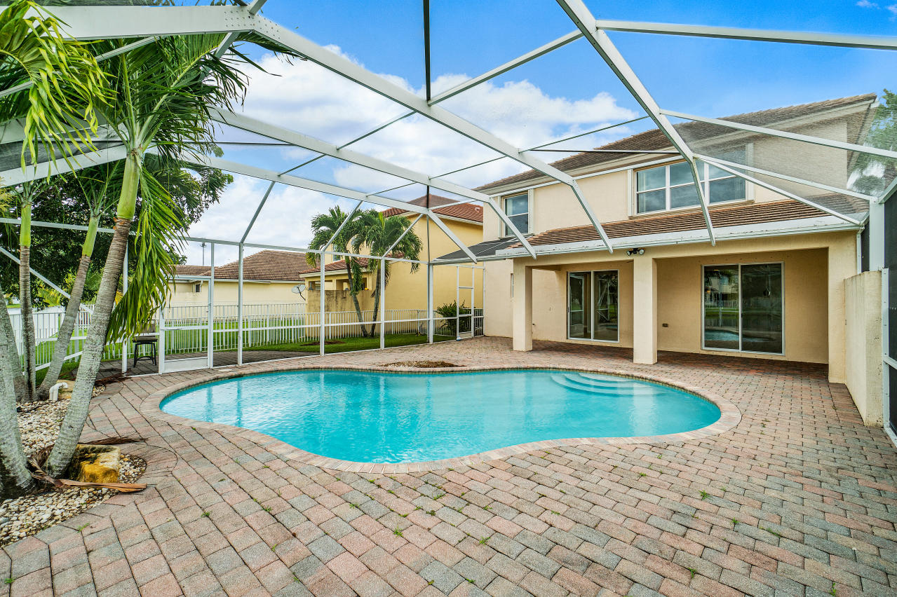 415 Mulberry Grove Road Royal Palm Beach, FL 33411 - Photo 29 of 39 a view of a patio with swimming pool table and chairs