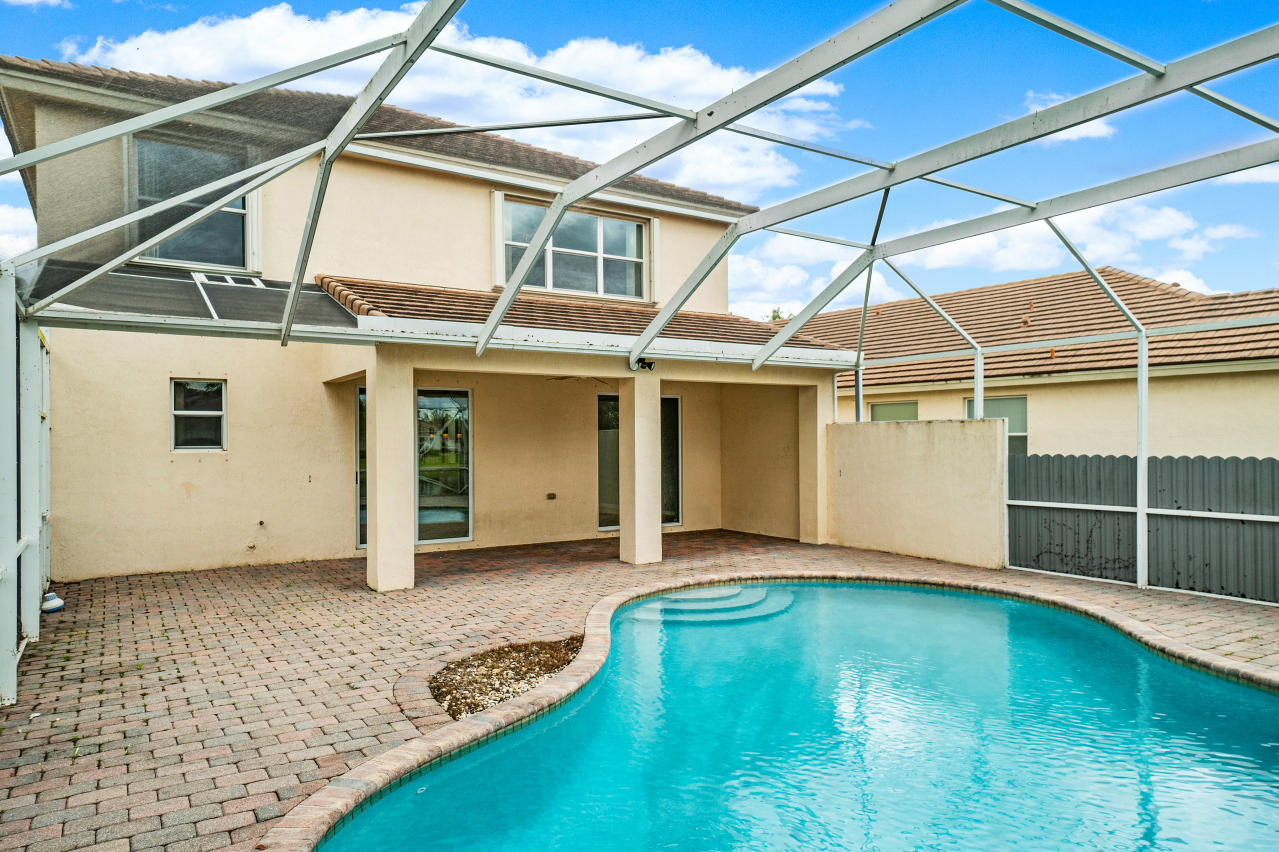 415 Mulberry Grove Road Royal Palm Beach, FL 33411 - Photo 30 of 39 a view of a house with a backyard