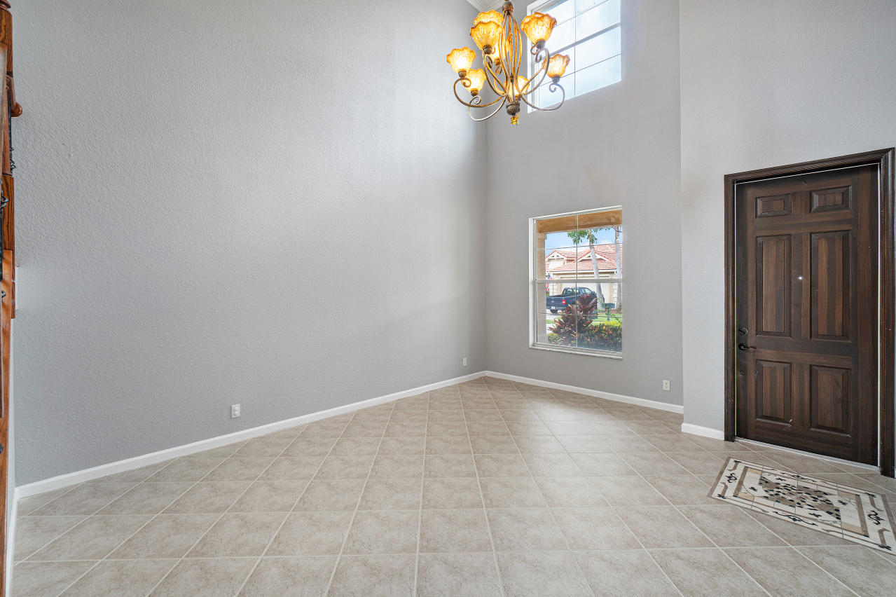 415 Mulberry Grove Road Royal Palm Beach, FL 33411 - Photo 3 of 39 an empty room with windows and chandelier