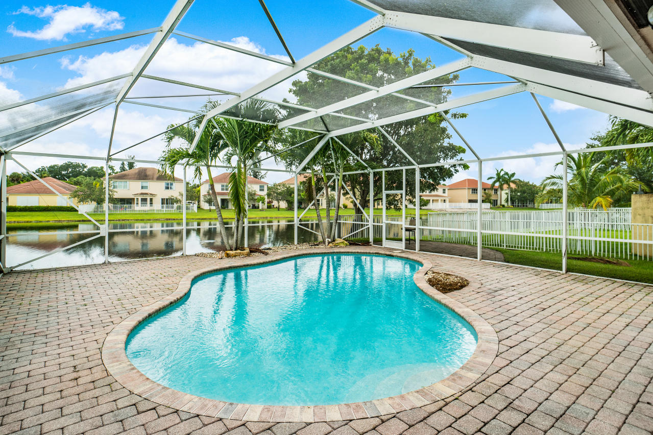 415 Mulberry Grove Road Royal Palm Beach, FL 33411 - Photo 31 of 39 a view of a backyard with swimming pool