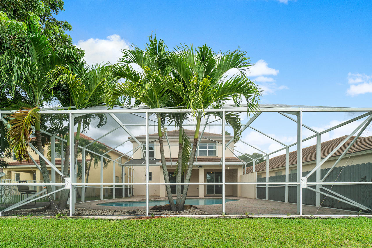 415 Mulberry Grove Road Royal Palm Beach, FL 33411 - Photo 32 of 39 a view of a swimming pool with a garden