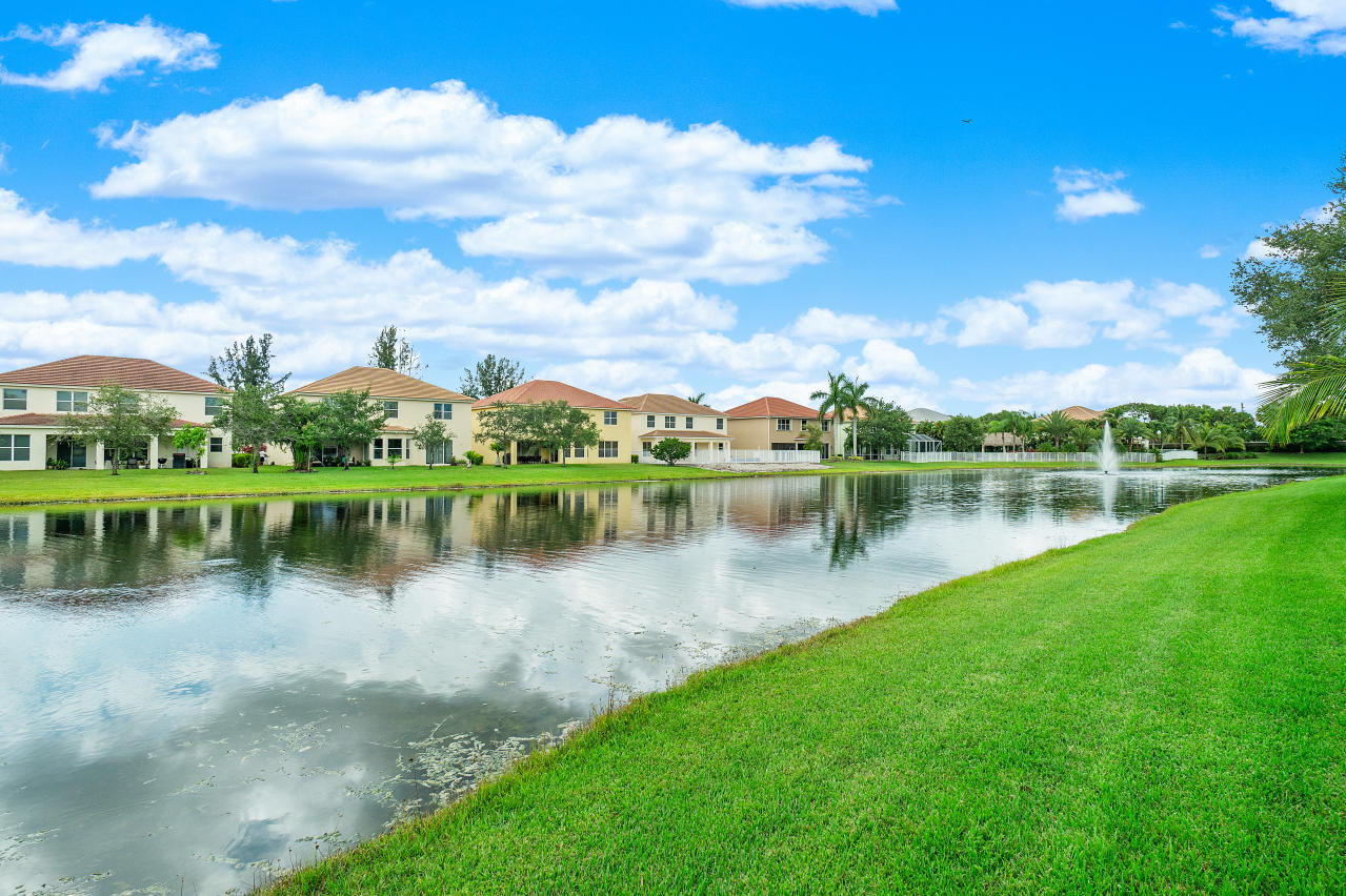 415 Mulberry Grove Road Royal Palm Beach, FL 33411 - Photo 35 of 39 a view of a lake with houses in the background