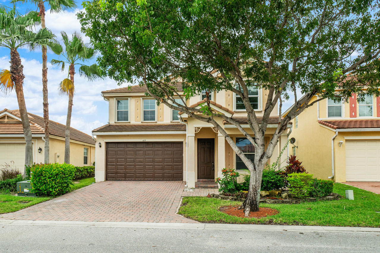 415 Mulberry Grove Road Royal Palm Beach, FL 33411 - Photo 39 of 39 a front view of a house with a garden and trees