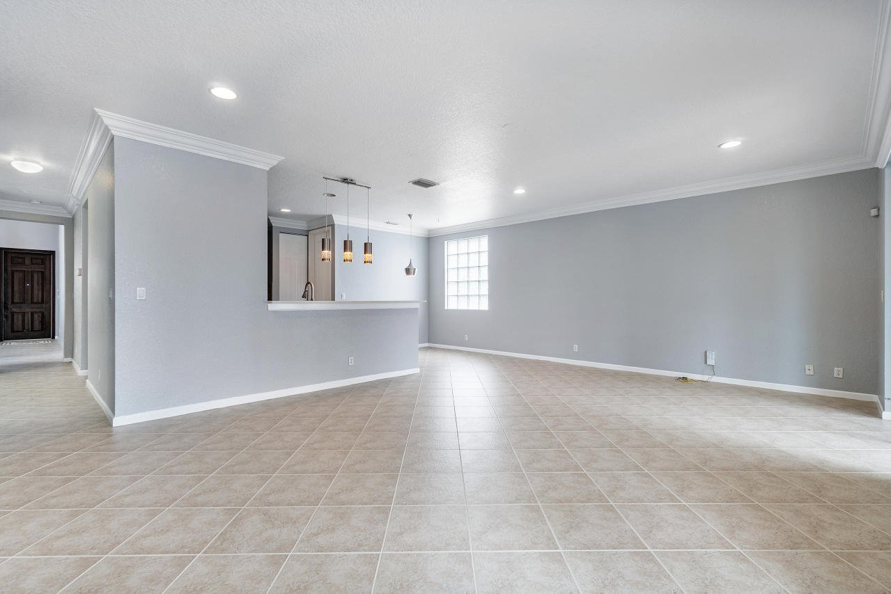 415 Mulberry Grove Road Royal Palm Beach, FL 33411 - Photo 10 of 39 wooden floor in an empty room with a window