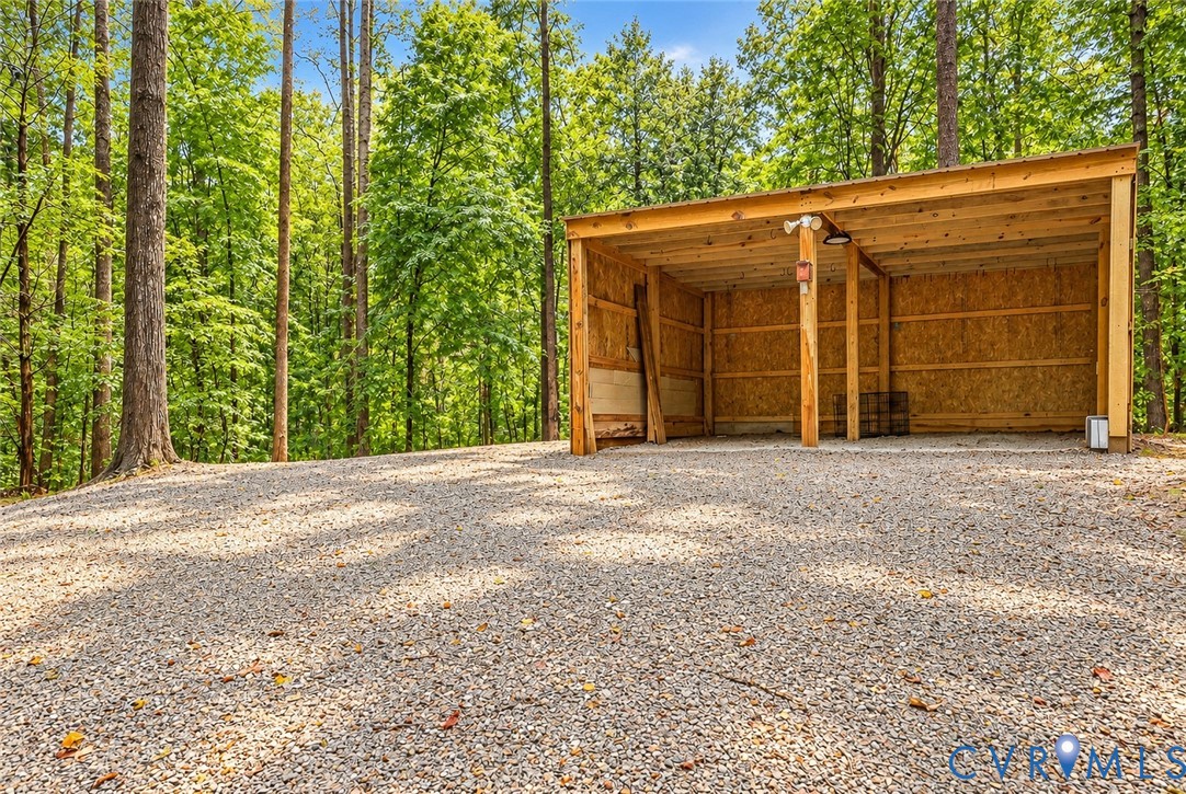 5369 Old Buckingham Road Powhatan, VA 23139 - Photo 5 of 28 Gravel parking area with a wood-frame shelter, fea