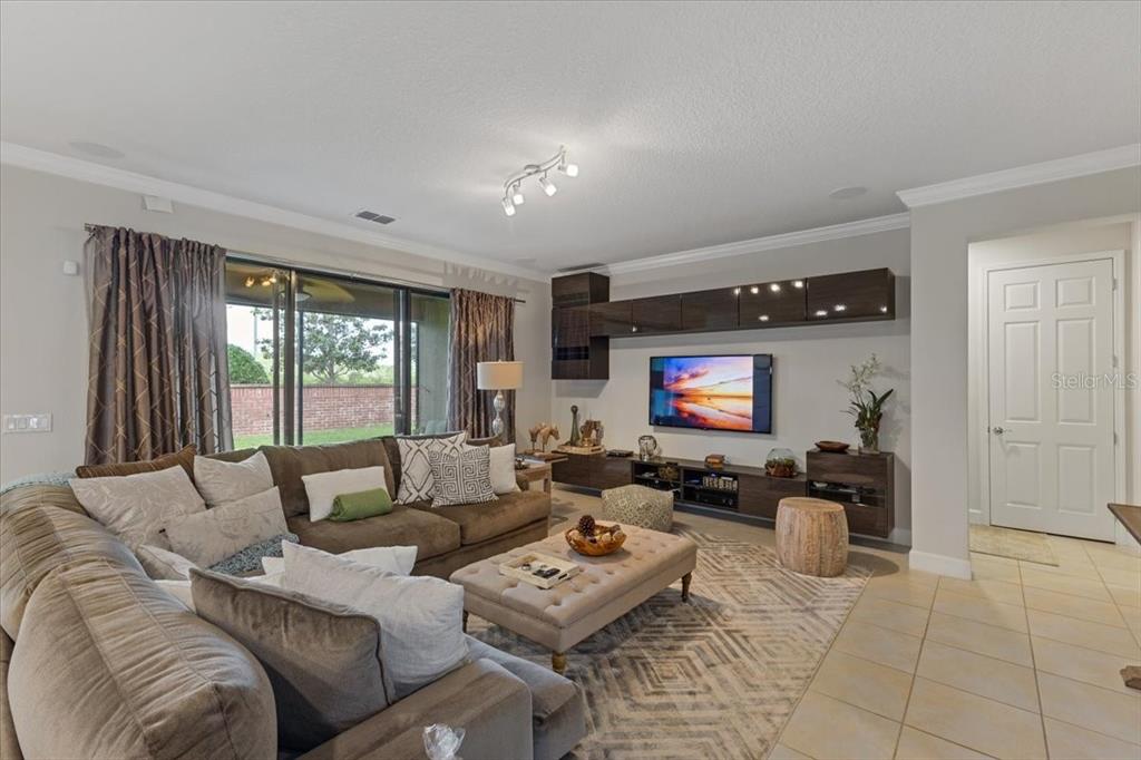 7180 Beek Street Windermere, FL 34786 - Photo 9 of 33 a living room with furniture and a flat screen tv