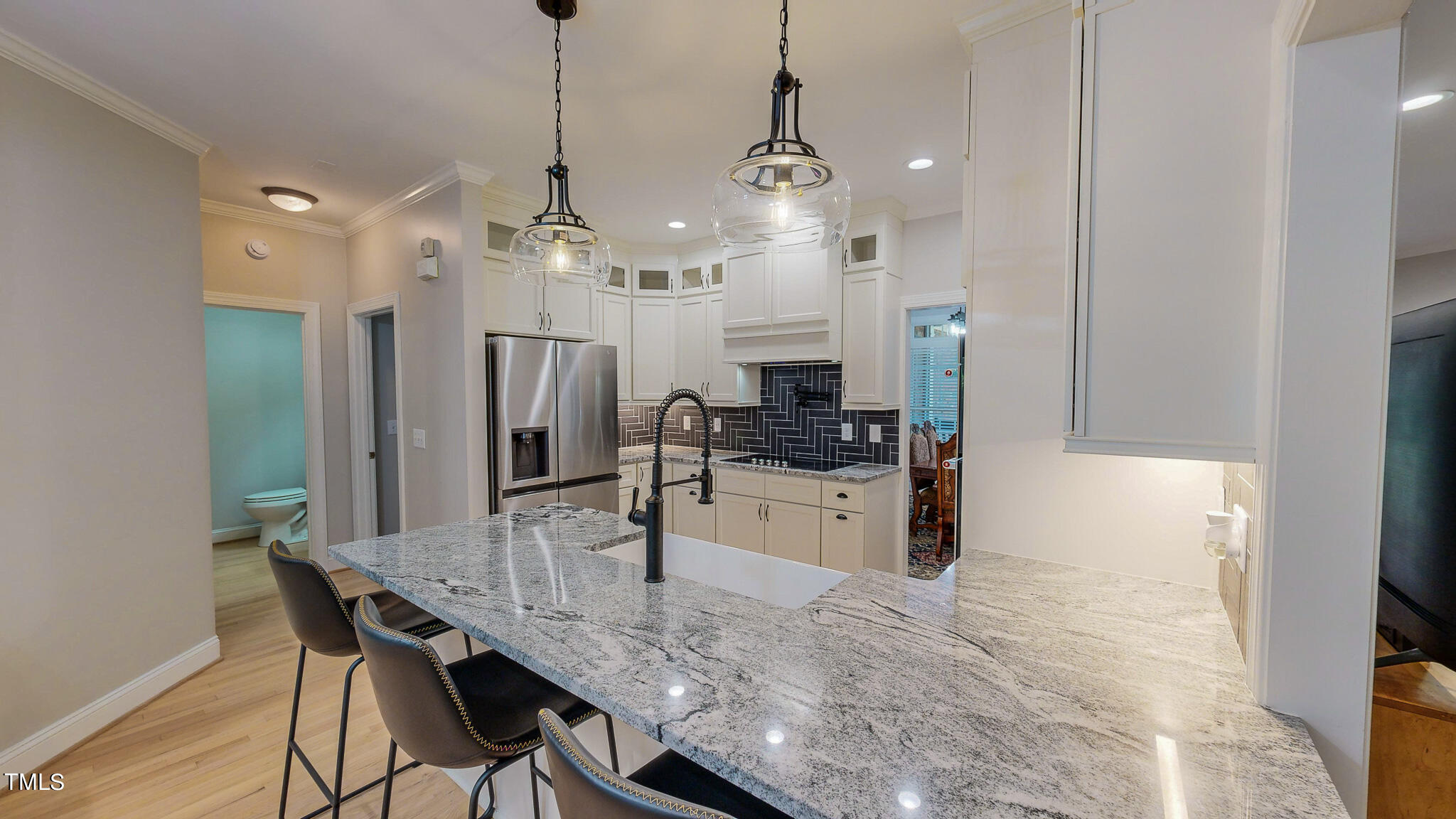 269 Oaks Lane Road Timberlake, NC 27583 - Photo 24 of 51 a kitchen with refrigerator cabinets dining table and chairs