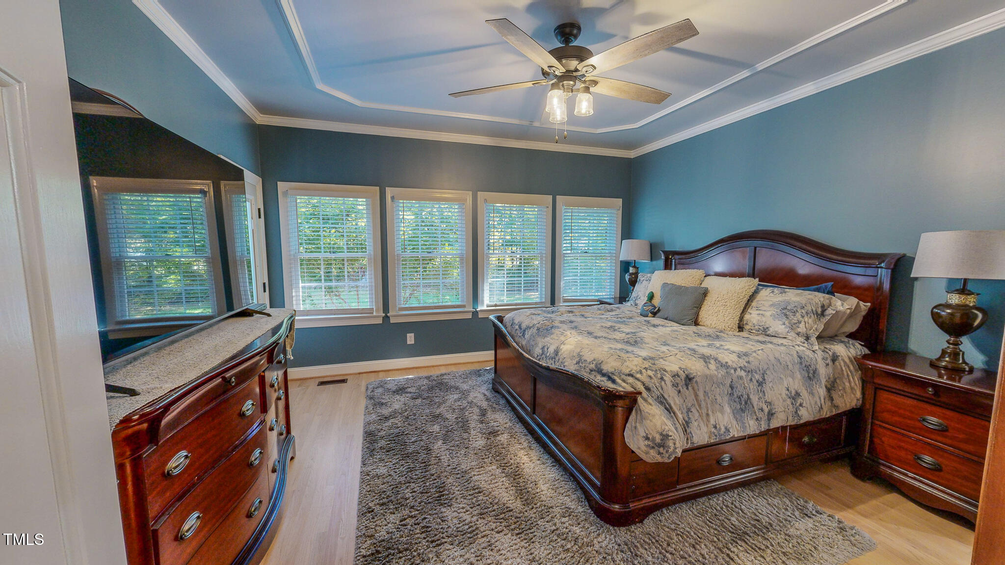 269 Oaks Lane Road Timberlake, NC 27583 - Photo 29 of 51 a spacious bedroom with a large bed and a chandelier fan