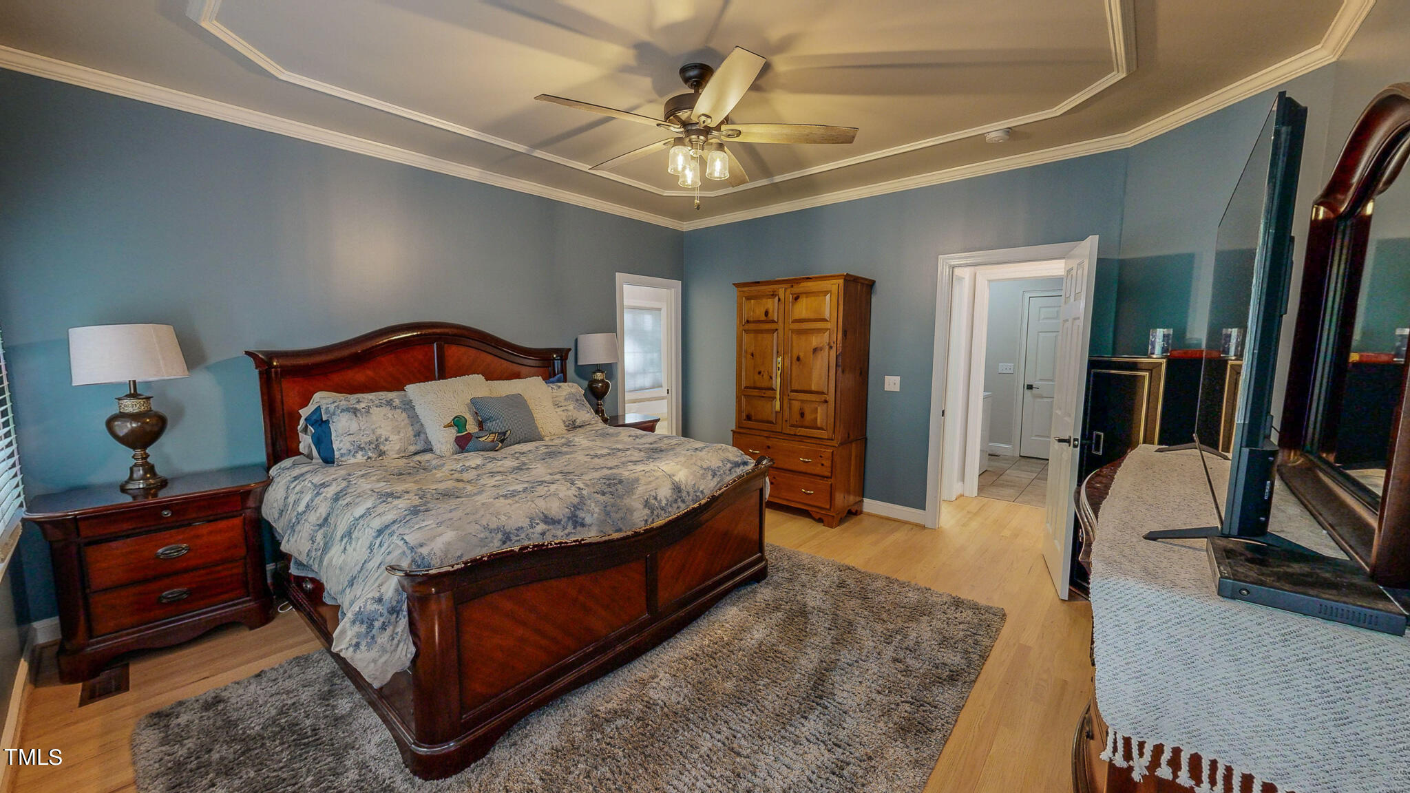 269 Oaks Lane Road Timberlake, NC 27583 - Photo 30 of 51 a bedroom with a bed a ceiling fan and a dresser