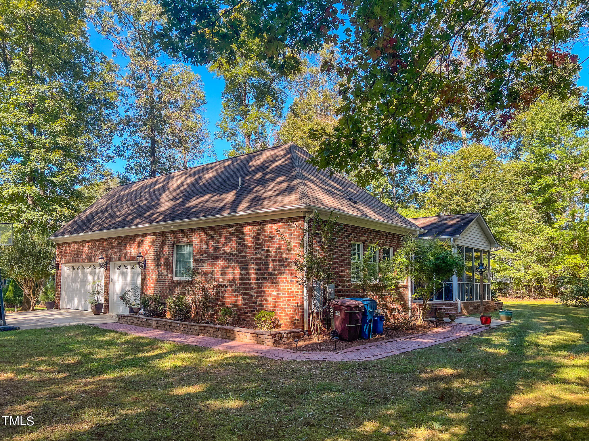 269 Oaks Lane Road Timberlake, NC 27583 - Photo 50 of 51 a view of a patio with table and chairs under an umbrella