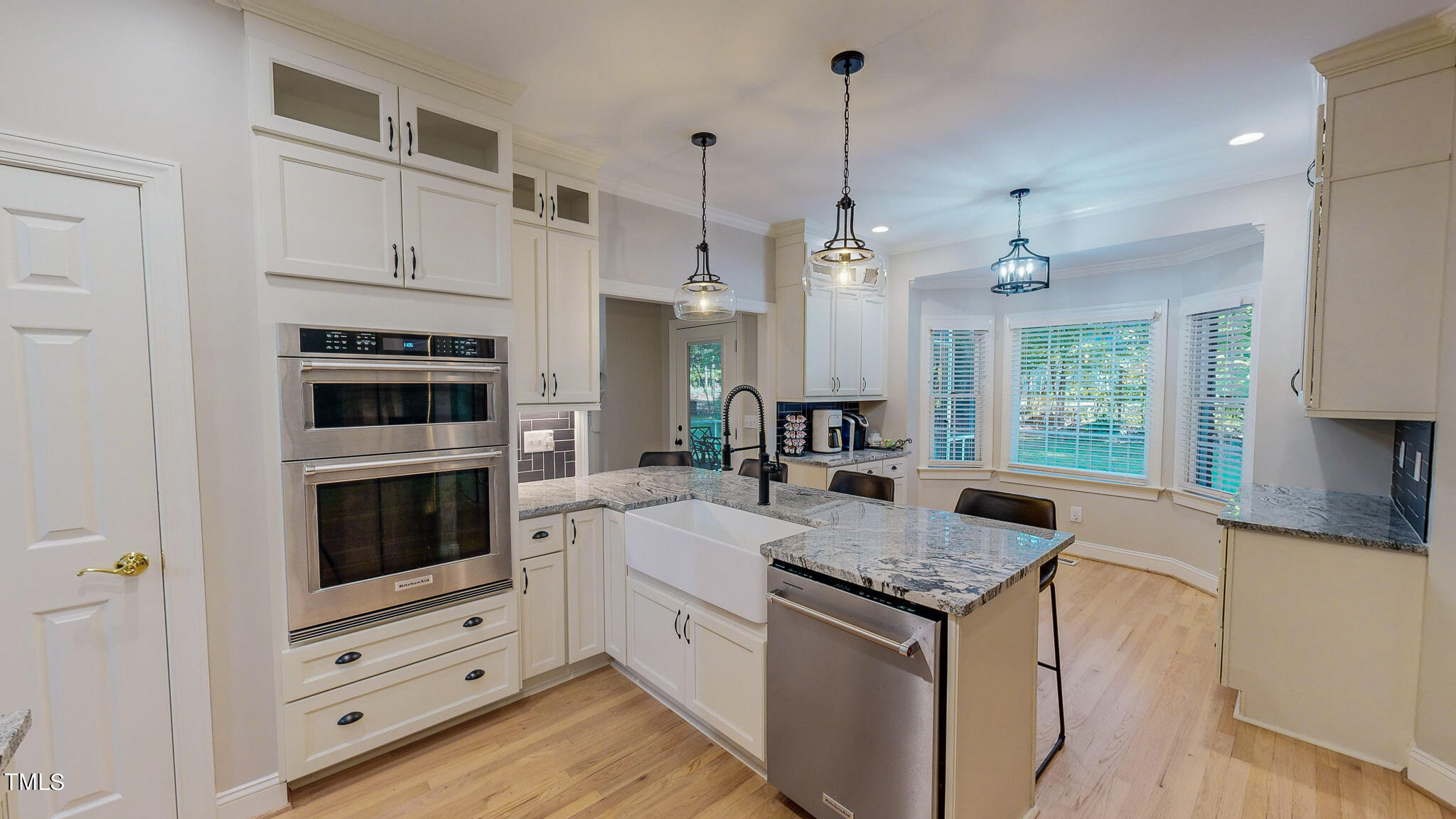 269 Oaks Lane Road Timberlake, NC 27583 - Photo 7 of 51 a kitchen with granite countertop a sink cabinets stainless steel appliances and a large window