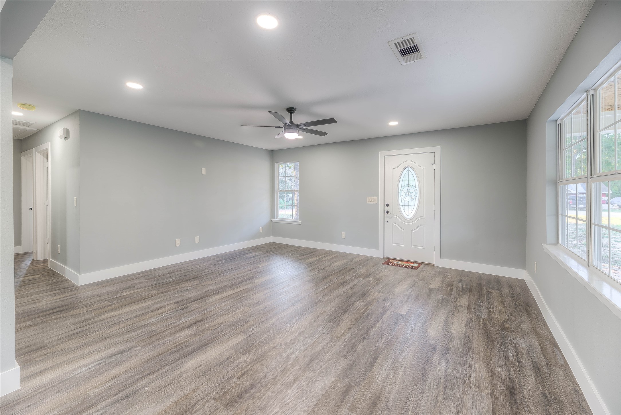388 Sunrise Wood Road Goodrich, TX 77335 - Photo 2 of 33 an empty room with wooden floor and windows