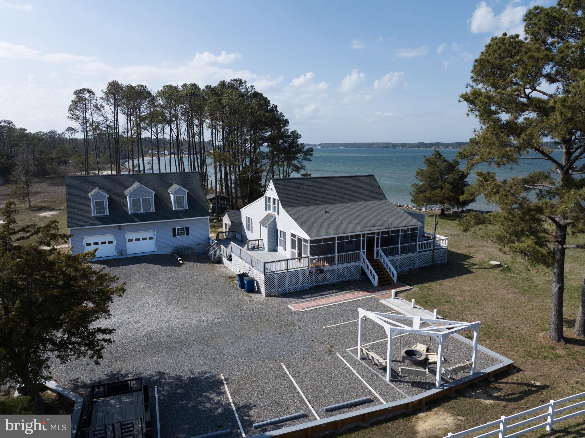 an aerial view of a house with table and chairs