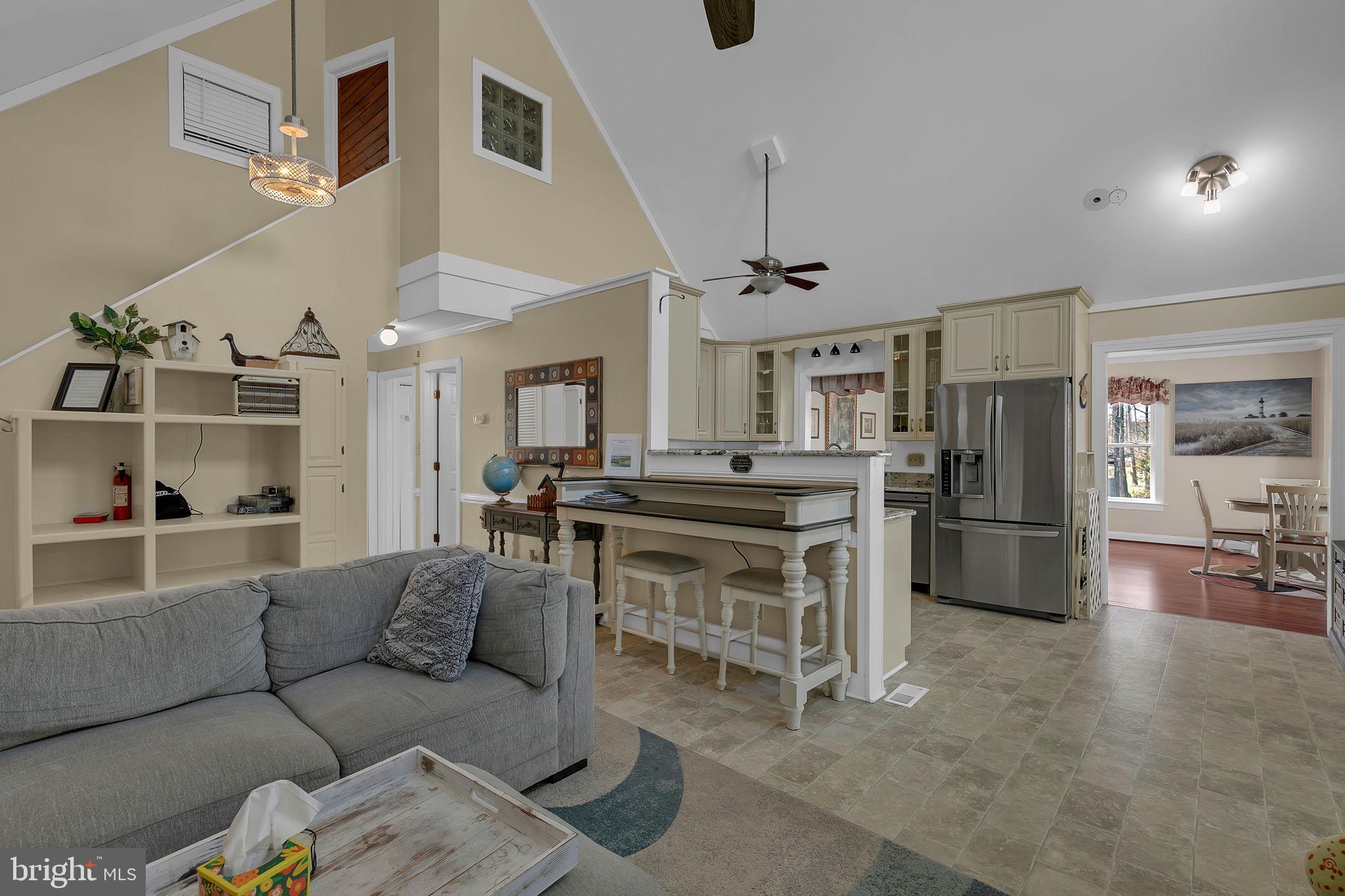 1887 Point Breeze Road Hudgins, VA 23076 - Photo 45 of 77 a living room with stainless steel appliances furniture a rug and a kitchen view