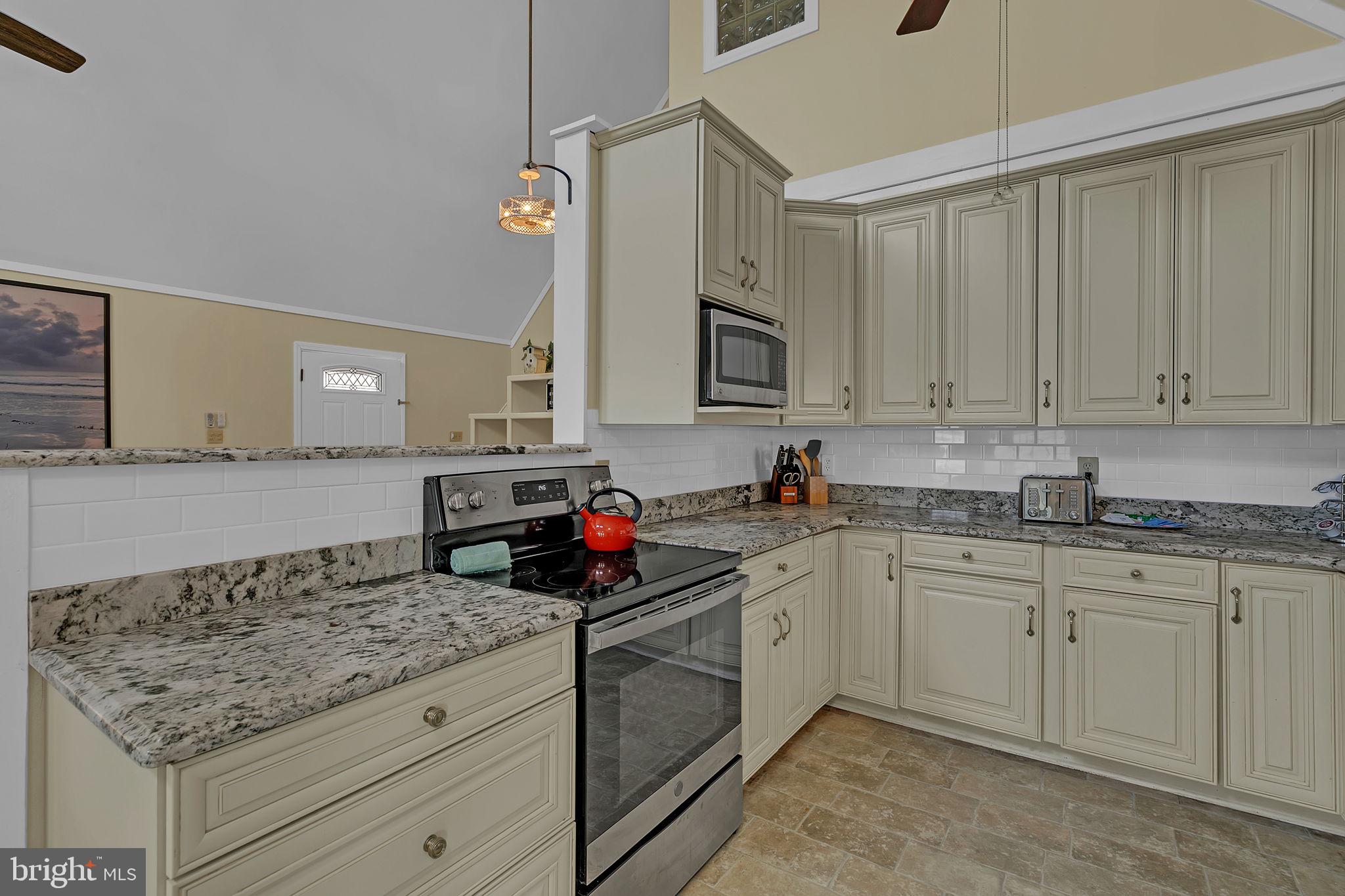 1887 Point Breeze Road Hudgins, VA 23076 - Photo 47 of 77 a kitchen with granite countertop a sink stove and cabinets