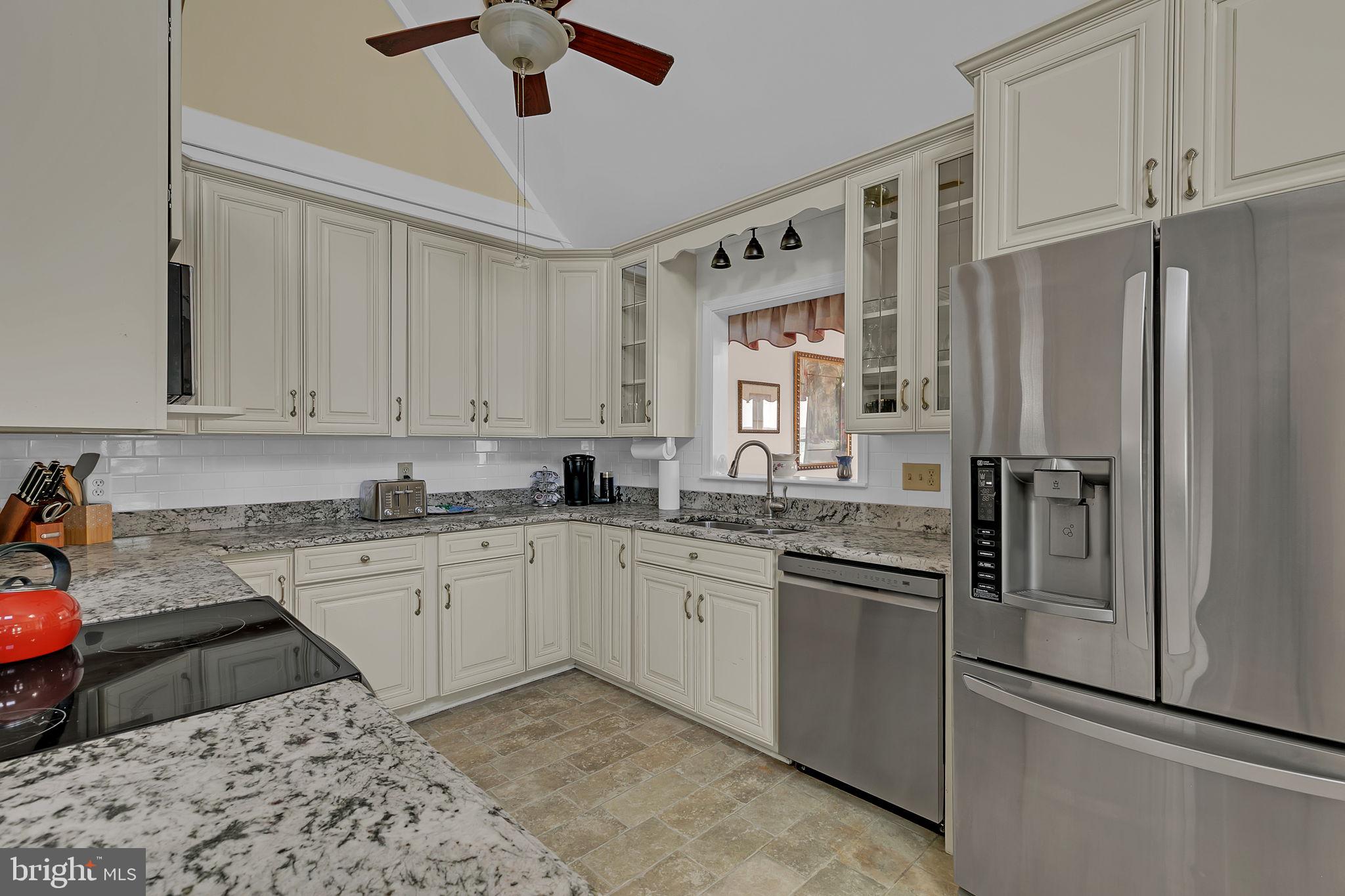 1887 Point Breeze Road Hudgins, VA 23076 - Photo 51 of 77 a kitchen with granite countertop a sink stainless steel appliances and cabinets