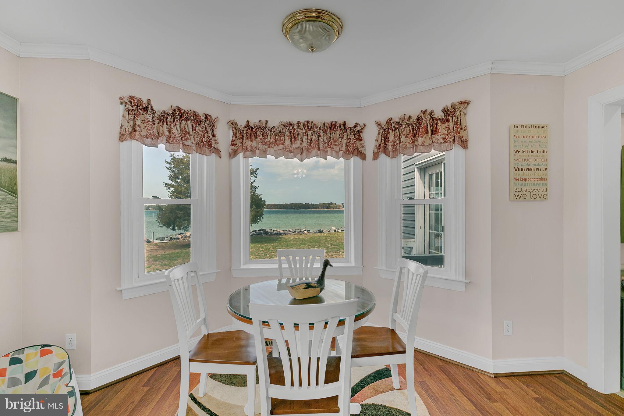 1887 Point Breeze Road Hudgins, VA 23076 - Photo 53 of 77 a view of a dining room with furniture a chandelier and wooden floor
