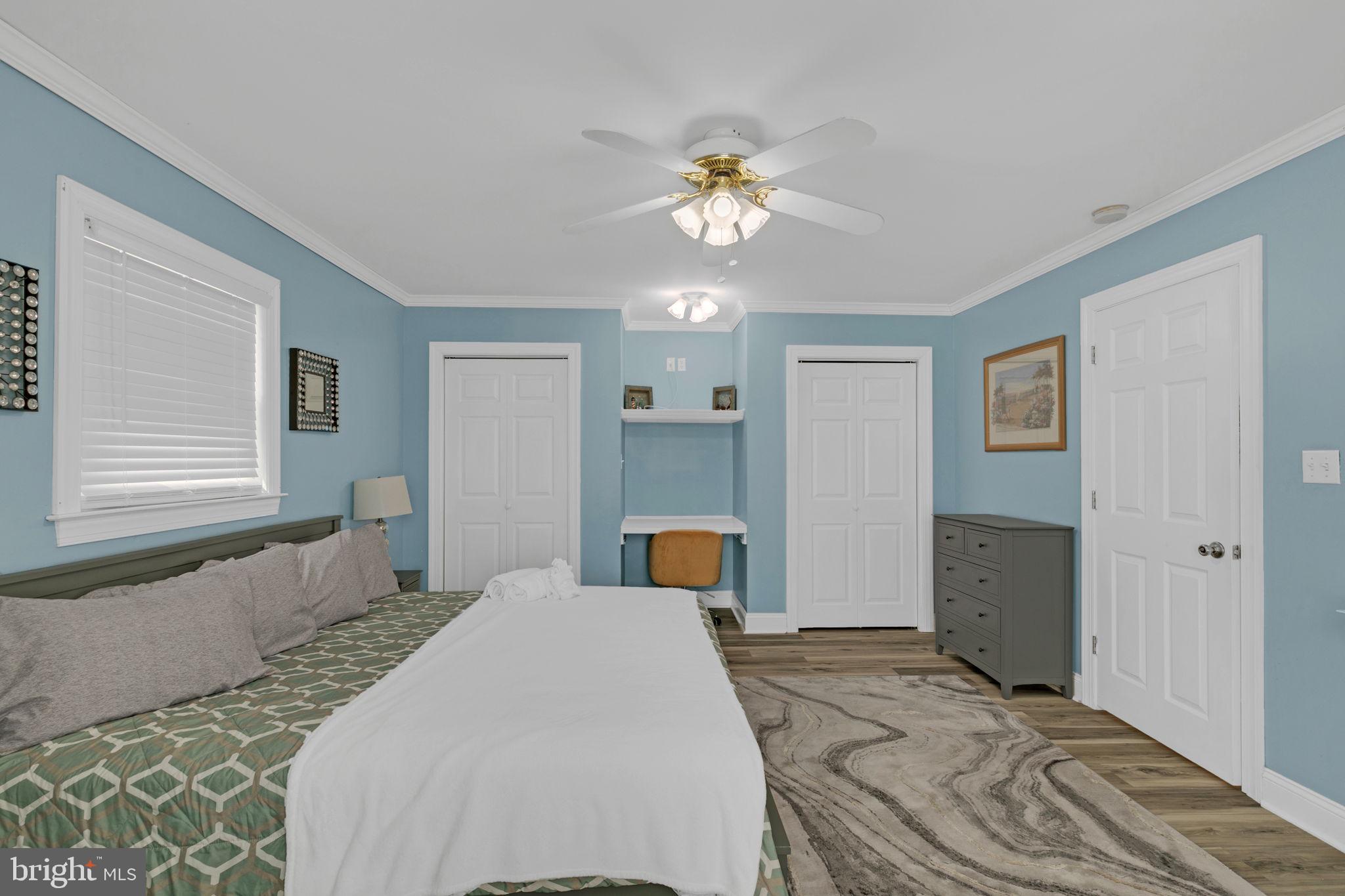 1887 Point Breeze Road Hudgins, VA 23076 - Photo 63 of 77 a bedroom with a bed and a chandelier