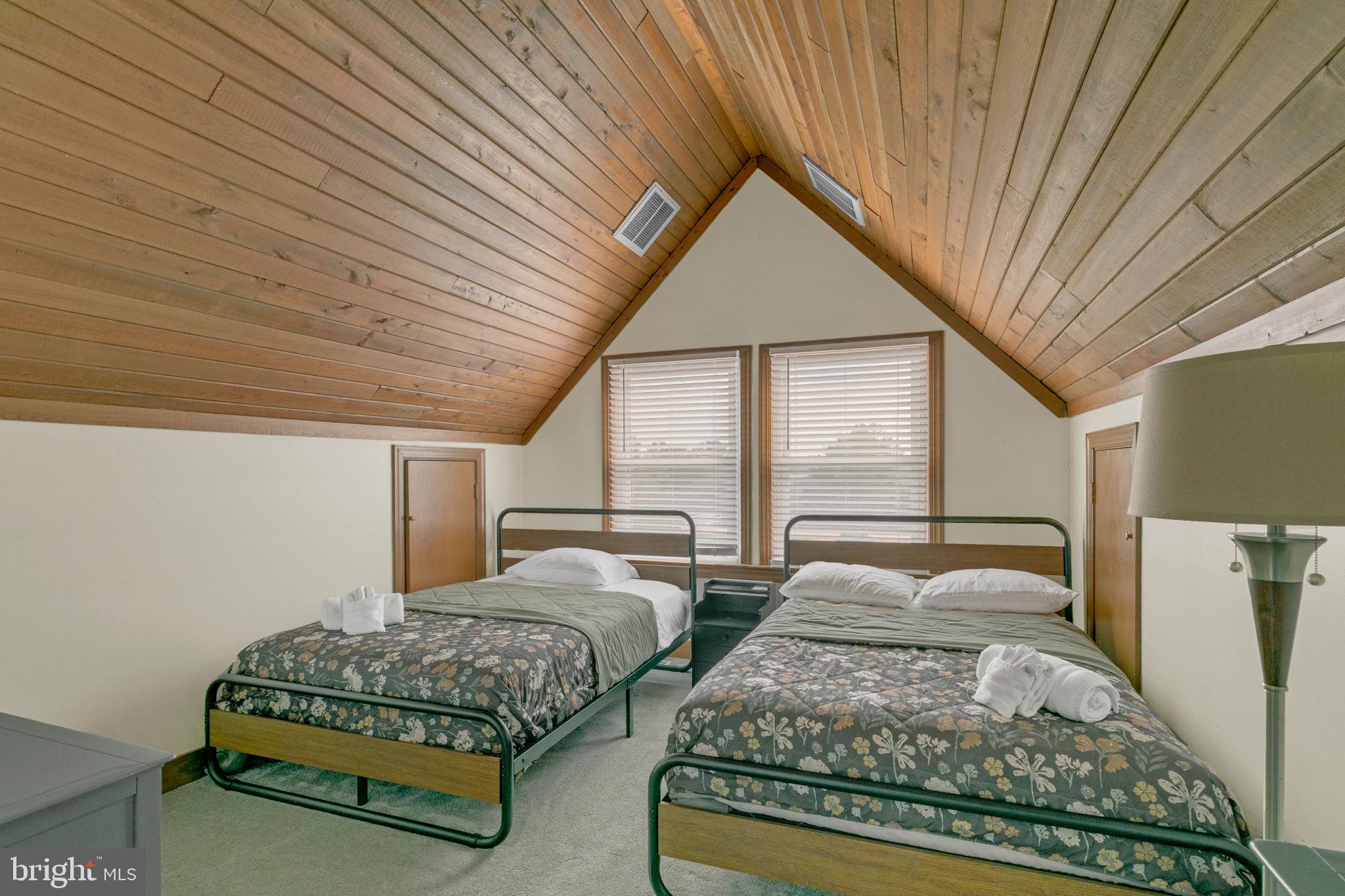 1887 Point Breeze Road Hudgins, VA 23076 - Photo 64 of 77 a bedroom with two beds and large window