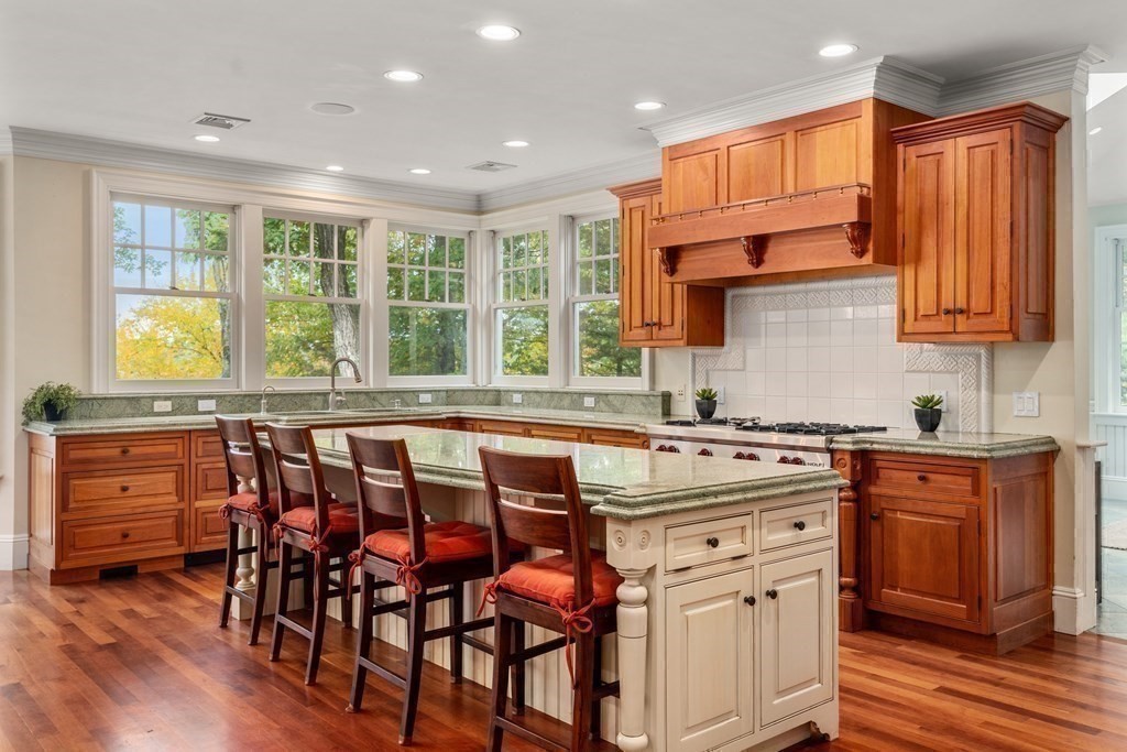 137 Forest Street Sherborn, MA 01770 - Photo 14 of 38 a kitchen with stainless steel appliances granite countertop a stove and cabinets