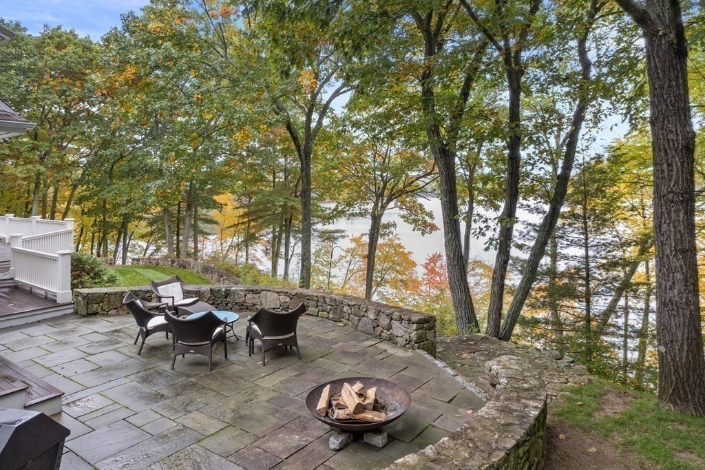 137 Forest Street Sherborn, MA 01770 - Photo 21 of 38 a view of a backyard with table and chairs and a fire pit