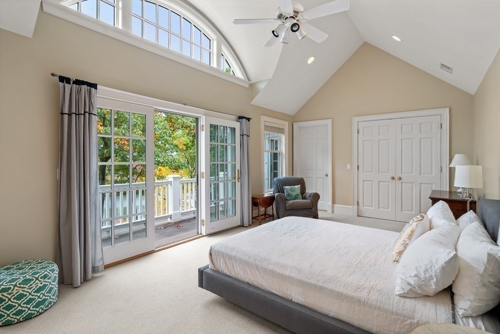 137 Forest Street Sherborn, MA 01770 - Photo 25 of 38 a spacious bedroom with a large bed and a chandelier
