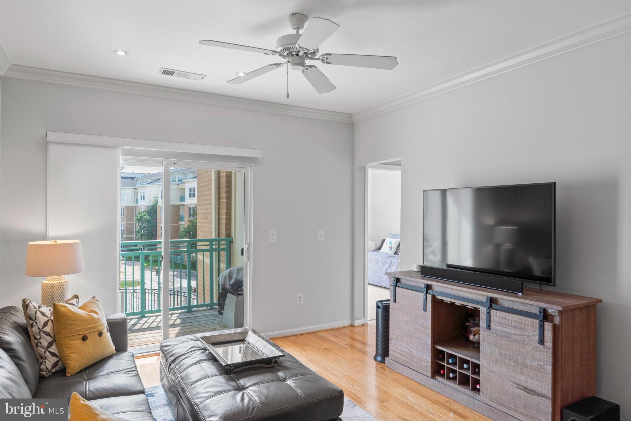 12001 Market Street, Unit 319 Reston, VA 20190 - Photo 11 of 37 Bright and airy living space with balcony access.