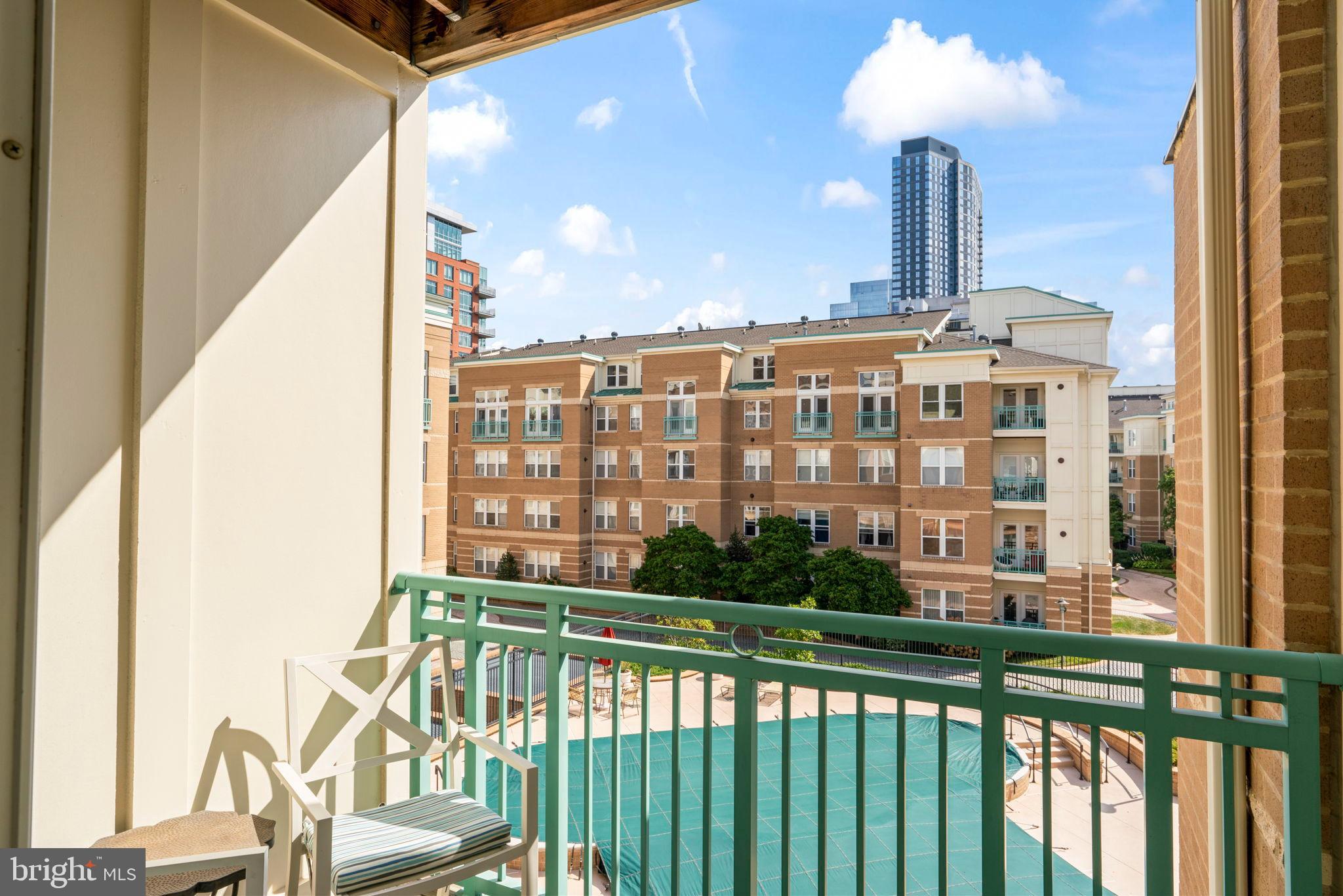 12001 Market Street, Unit 319 Reston, VA 20190 - Photo 15 of 37 Urban balcony view with city skyline.