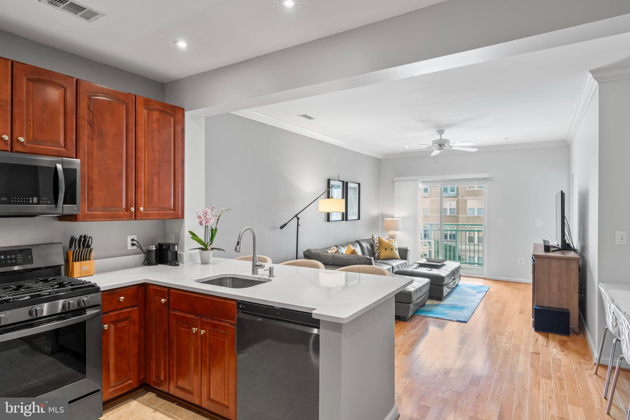 12001 Market Street, Unit 319 Reston, VA 20190 - Photo 2 of 37 Kitchen flows into a bright living space.