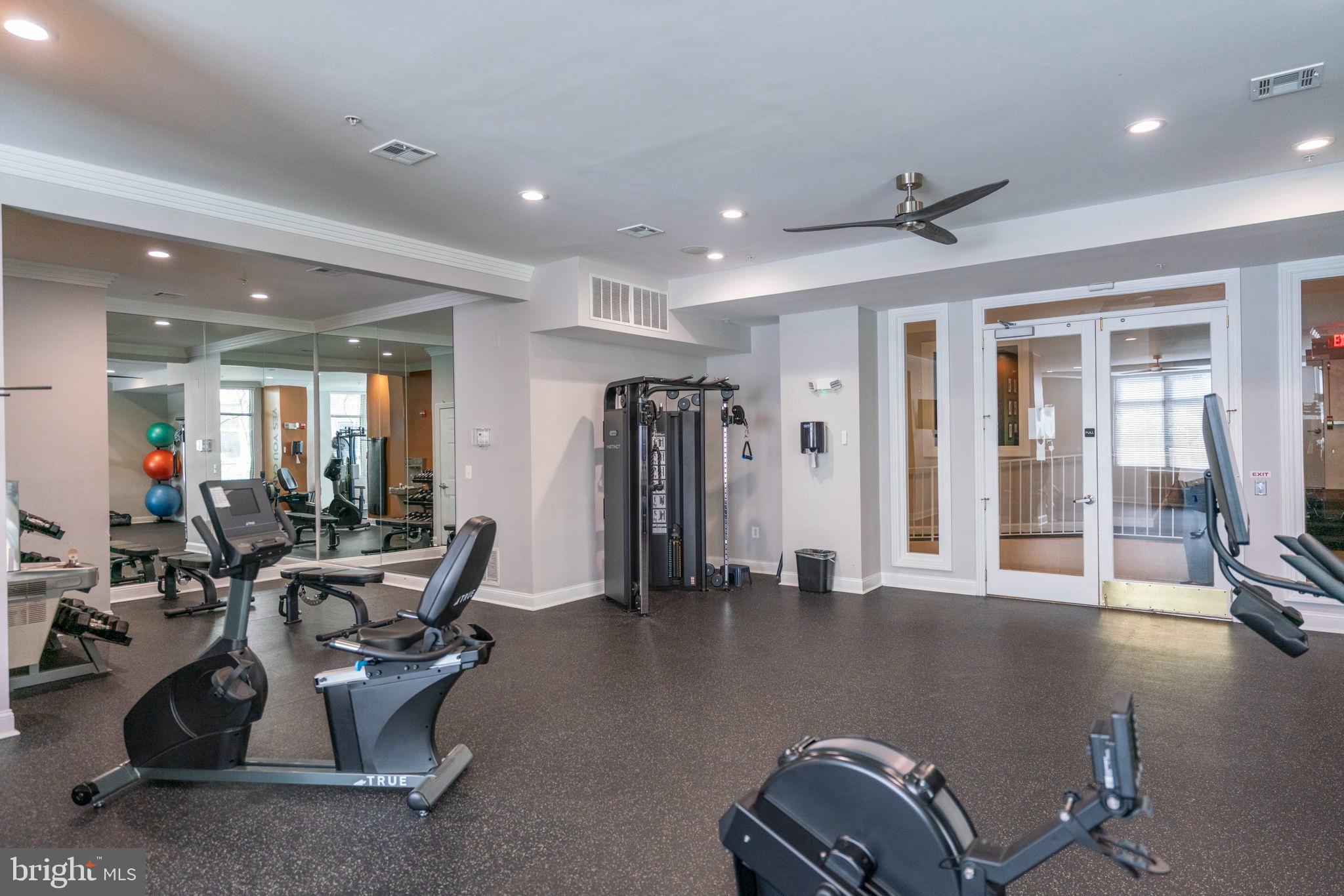 12001 Market Street, Unit 319 Reston, VA 20190 - Photo 29 of 37 Modern fitness center with sleek equipment.