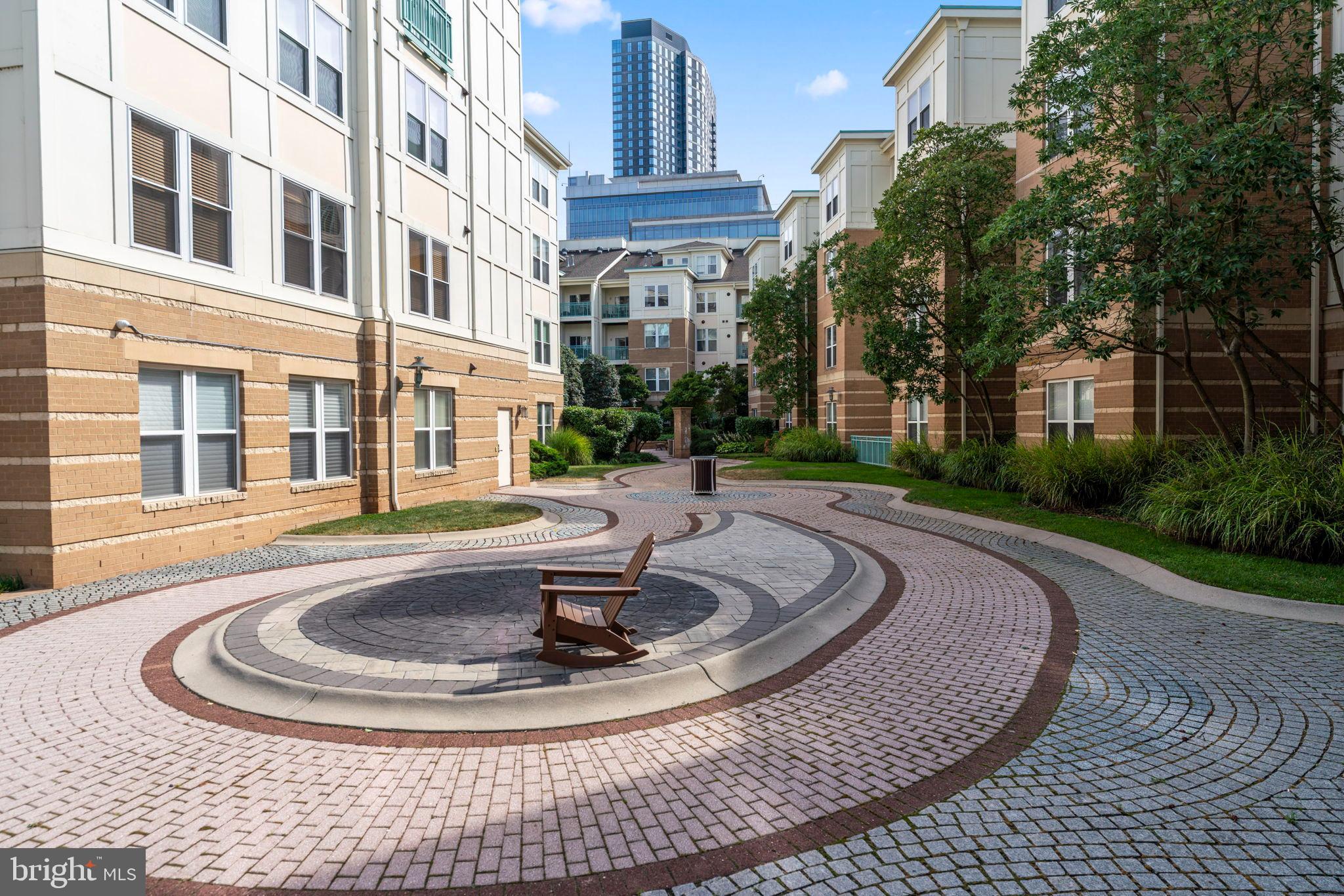 12001 Market Street, Unit 319 Reston, VA 20190 - Photo 33 of 37 Serene courtyard with winding pathways.
