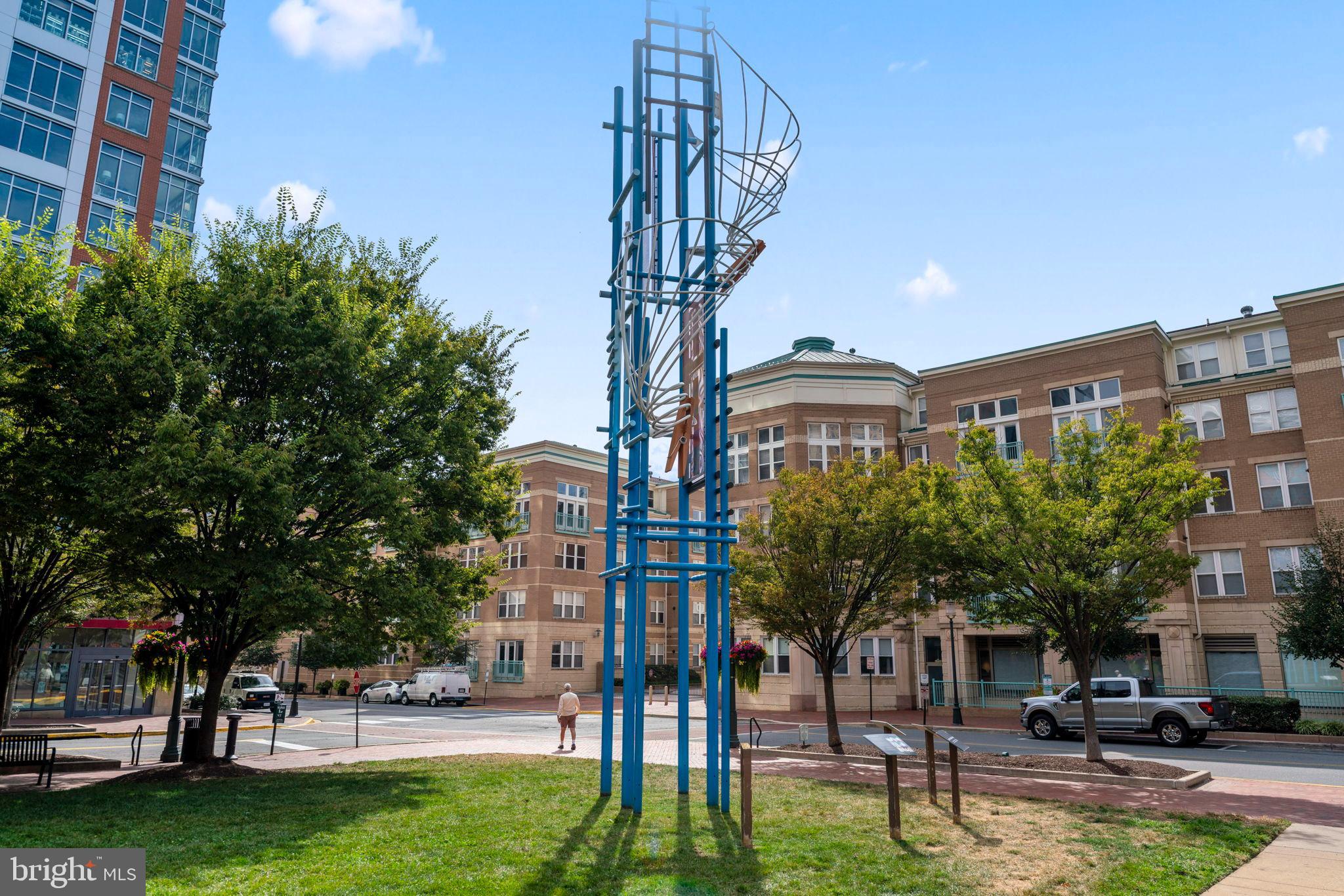 12001 Market Street, Unit 319 Reston, VA 20190 - Photo 36 of 37 Artful sculpture amidst urban greenery.