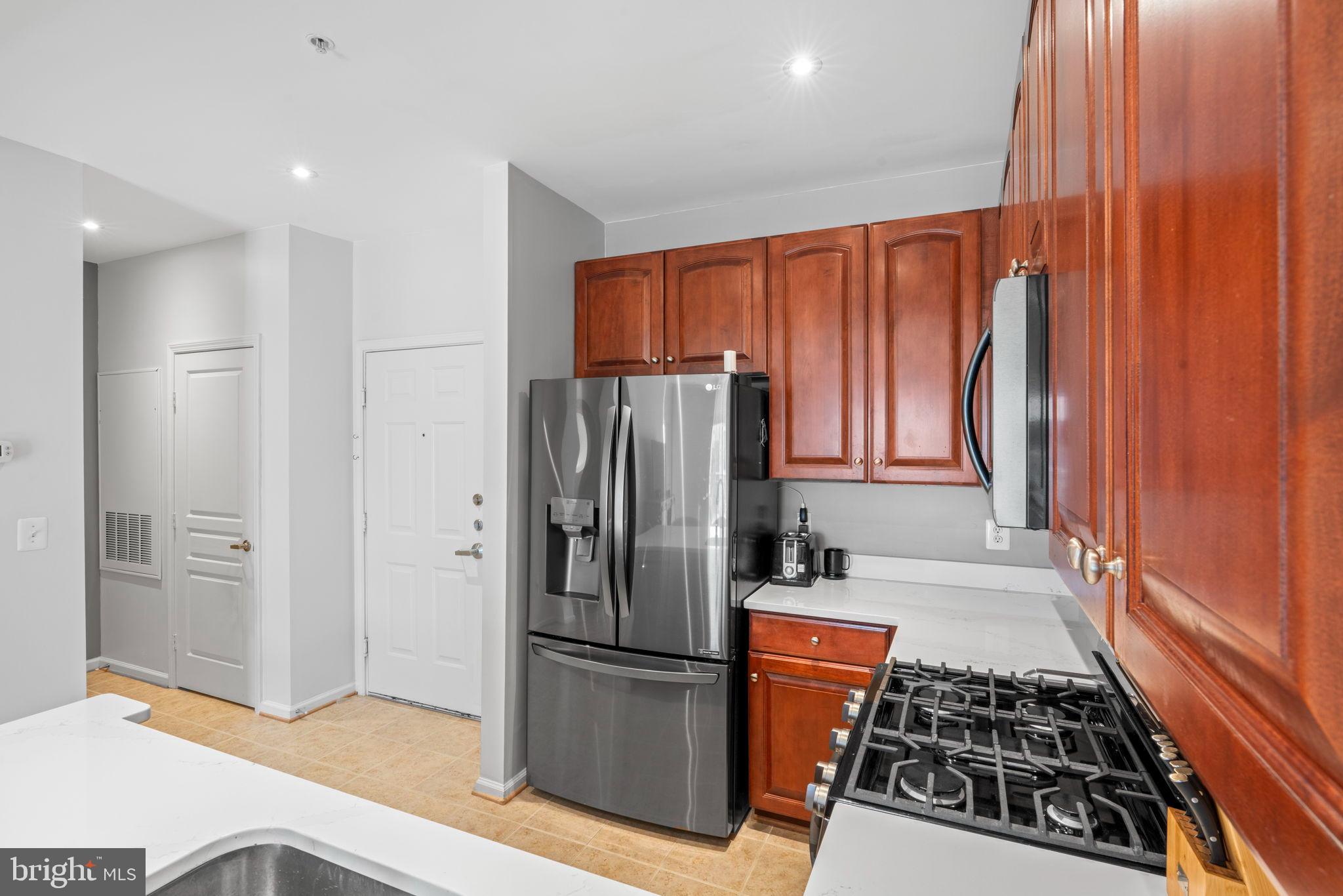 12001 Market Street, Unit 319 Reston, VA 20190 - Photo 4 of 37 Updated black stainless appliances
