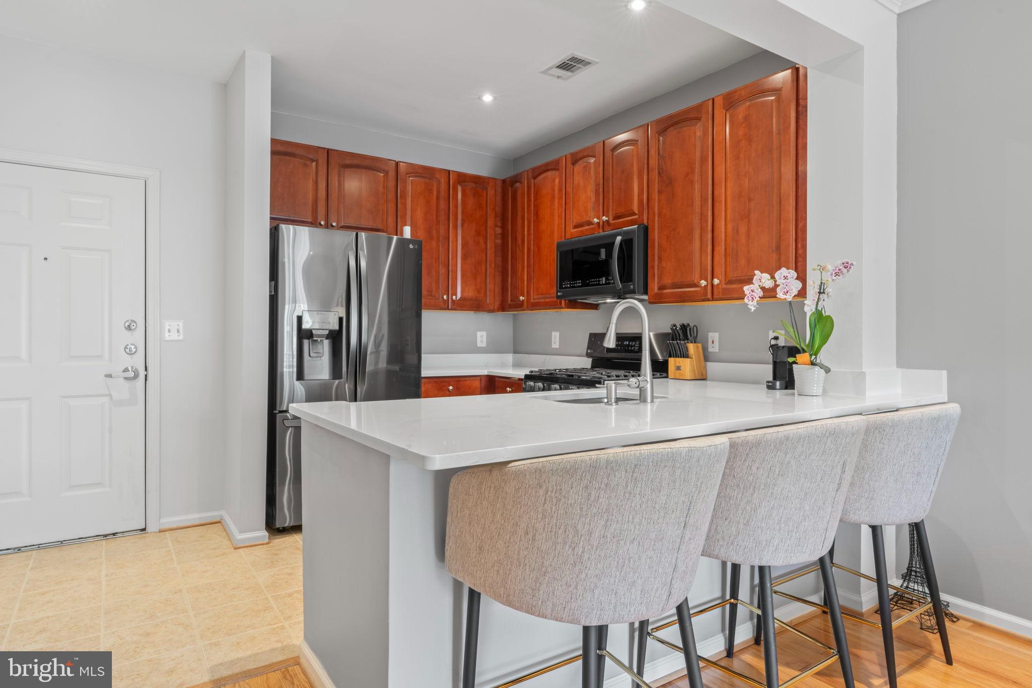 12001 Market Street, Unit 319 Reston, VA 20190 - Photo 5 of 37 Grantie counter with seating for three