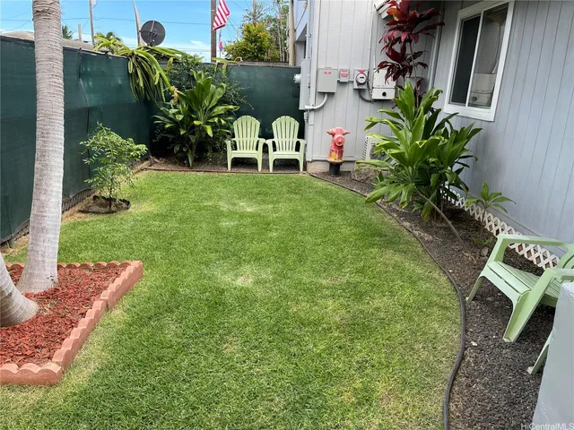 a view of an house with backyard space and sitting area