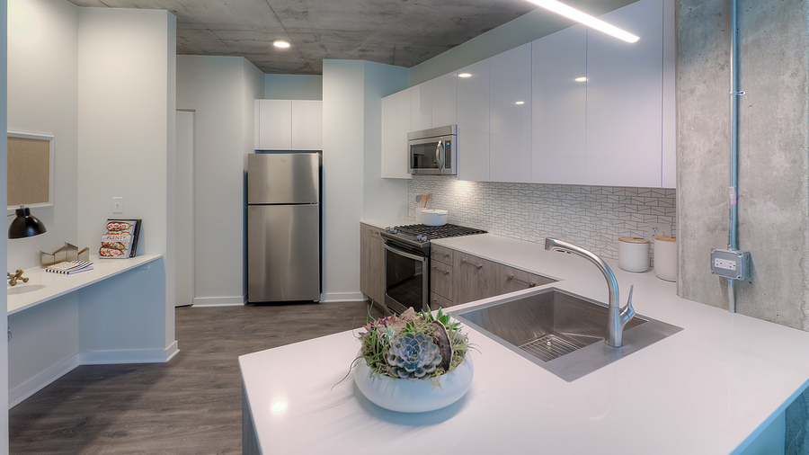 Undisclosed Address Chicago, IL 60657 - Photo 4 of 8 a kitchen with stainless steel appliances granite countertop a sink a stove a microwave a refrigerator a white table and chairs