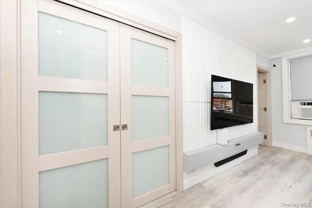 a view of a hallway with wooden floor and furniture