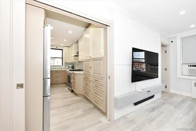a kitchen with white cabinets and white appliances