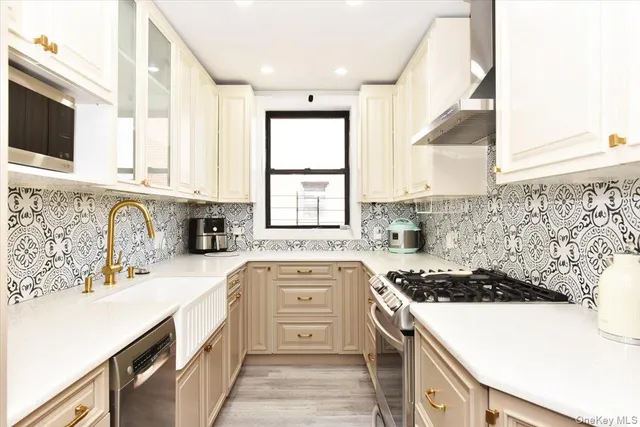 a kitchen with a sink stove top oven and cabinets