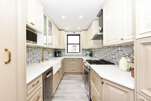a kitchen with a sink a stove and cabinets