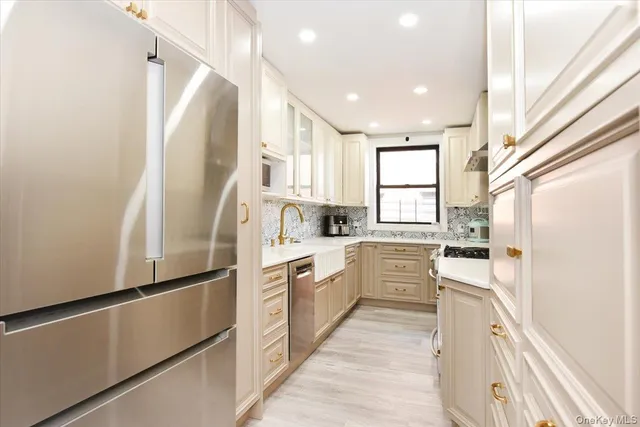a kitchen with white cabinets and white appliances