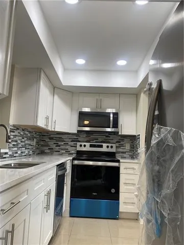 a kitchen with stainless steel appliances granite countertop a stove and a sink