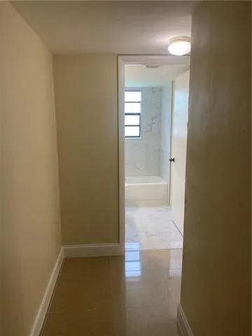 a view of a bathroom with a glass door and a window