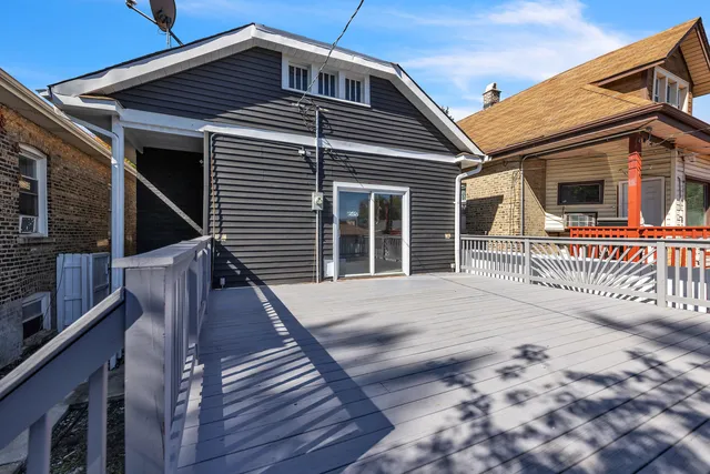 an aerial view of a house with a yard and outdoor seating
