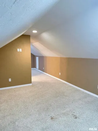 a view of an empty room with a fireplace