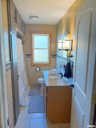 a bathroom with a sink a toilet and mirror