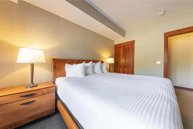 a bedroom with bed and lamp